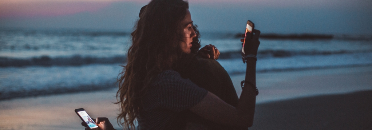 Couple isolates each other by looking at their phones