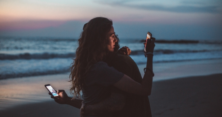 Couple isolates each other by looking at their phones
